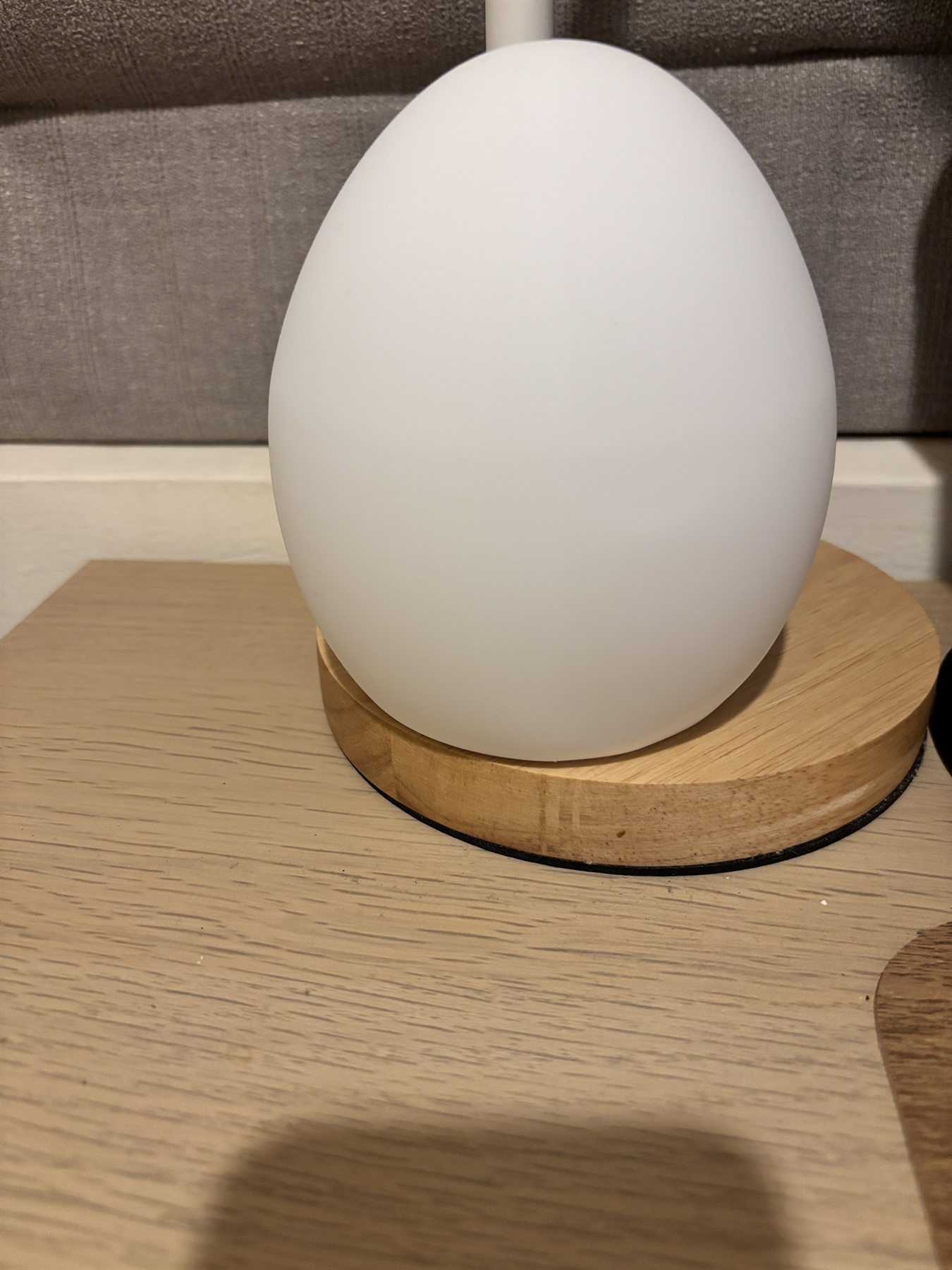 Owlnest Lume physical sample turned off with wooden base